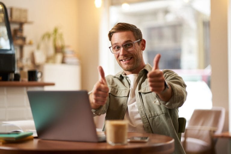 Small business owner smiling while mastering emails that get clicked with SendSteed