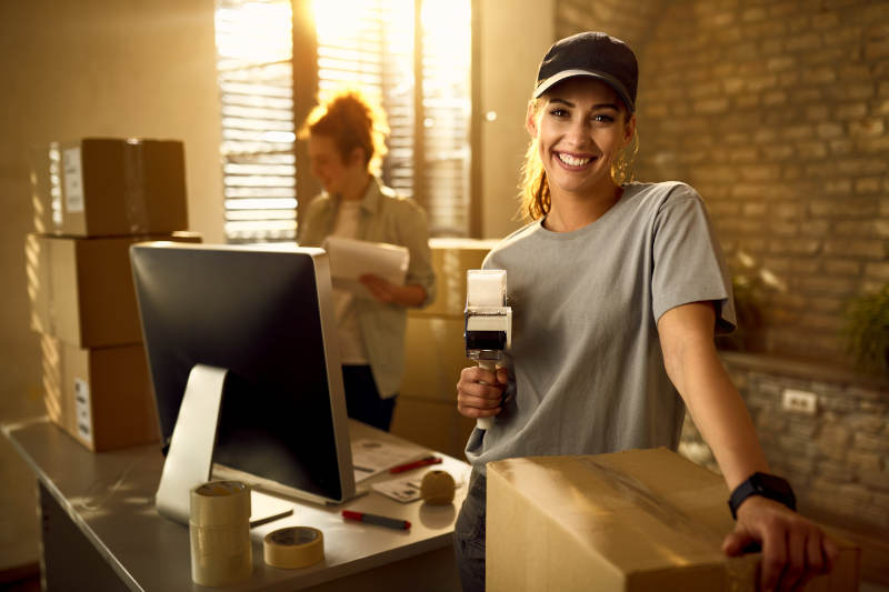 What’s a Side Hustle and How It Can Transform Your Life in 2025 2 Small business owner packaging Etsy orders, showcasing what is a side hustle in 2025.