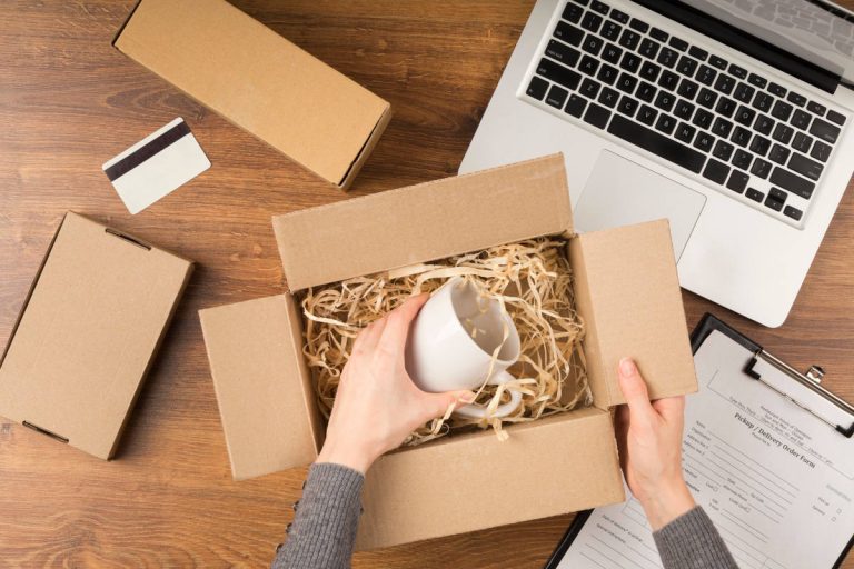 Small business owner packaging Etsy orders, showcasing what is a side hustle in 2025