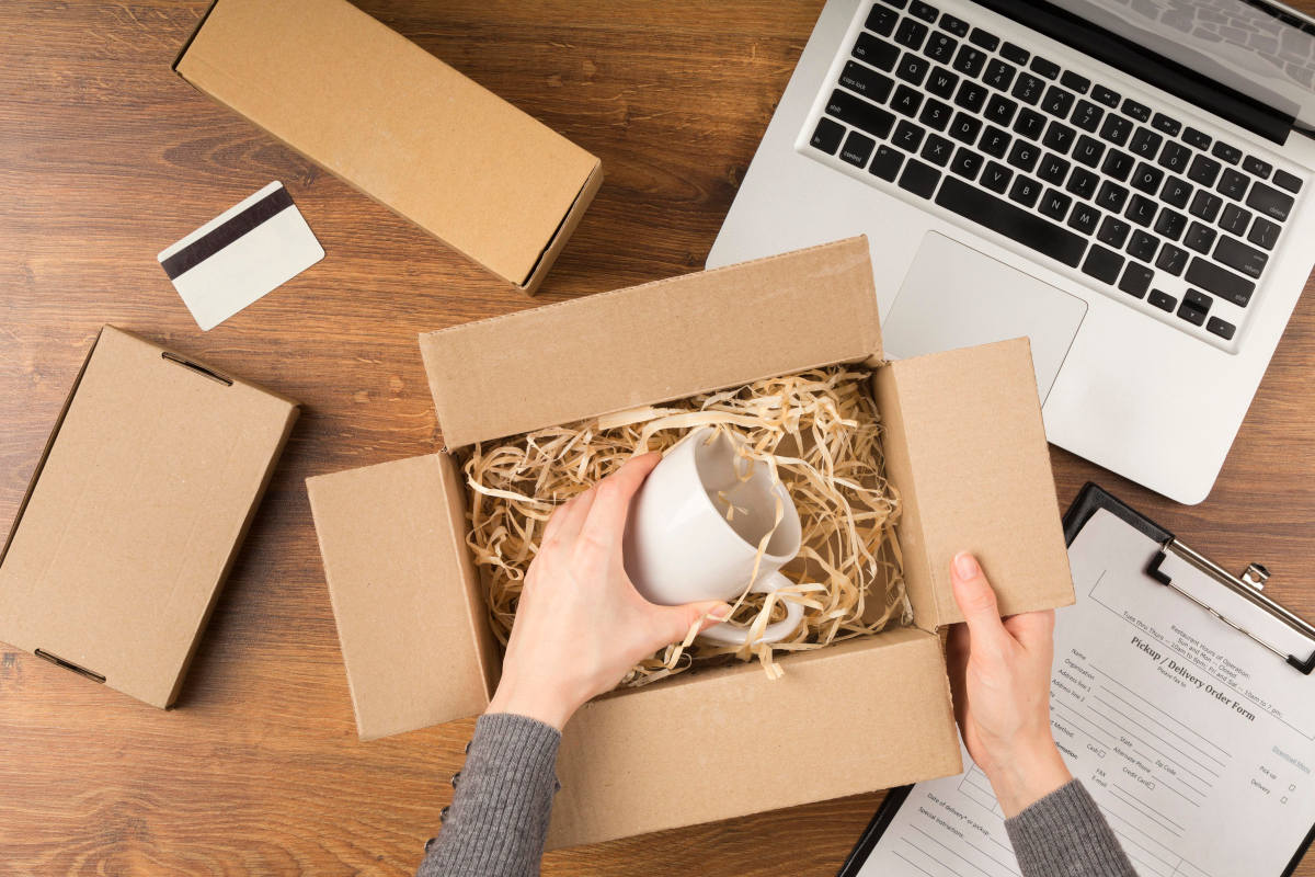 Small business owner packaging Etsy orders, showcasing what is a side hustle in 2025