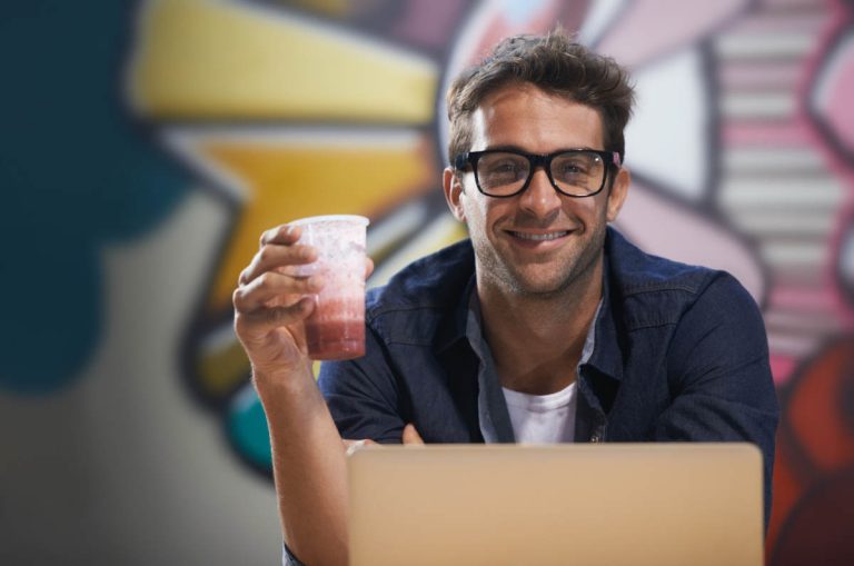 Smiling entrepreneur packaging Etsy orders, showing what side hustle is best for you in 2025.
