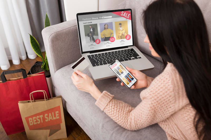 Laptop and phone showing platforms for what side hustle is best for you in 2025.